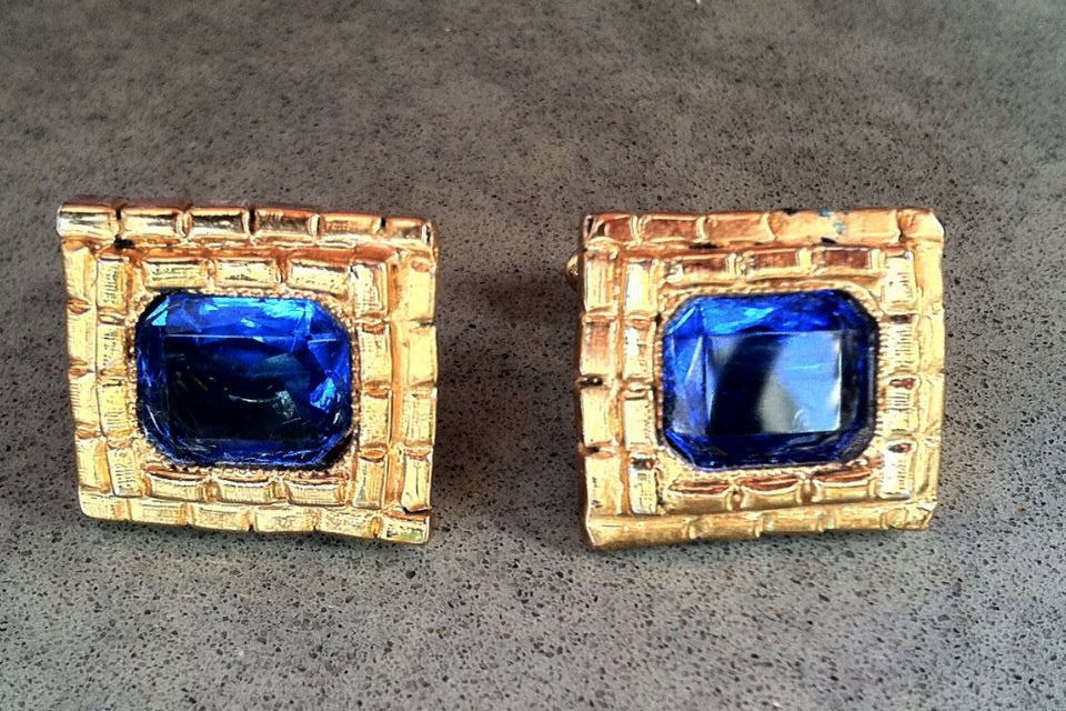 A rare vintage pair William de Lillo 'jeweled' cuff links. Authentic gilt metal items feature vivid blue faceted crystal centers.

Rare item from the William de Lillo archives.

William de Lillo (deceased 2011) was born in Belgium and came to