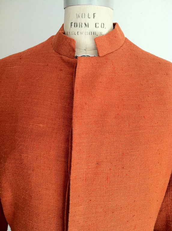 A vintage Nehru jacket custom ordered by the jeweler William de Lillo. Orange linen weave silk item featutes a hidden button front and double back vents.

Rare item from the William de Lillo archives.

William de Lillo (deceased 2011) was born