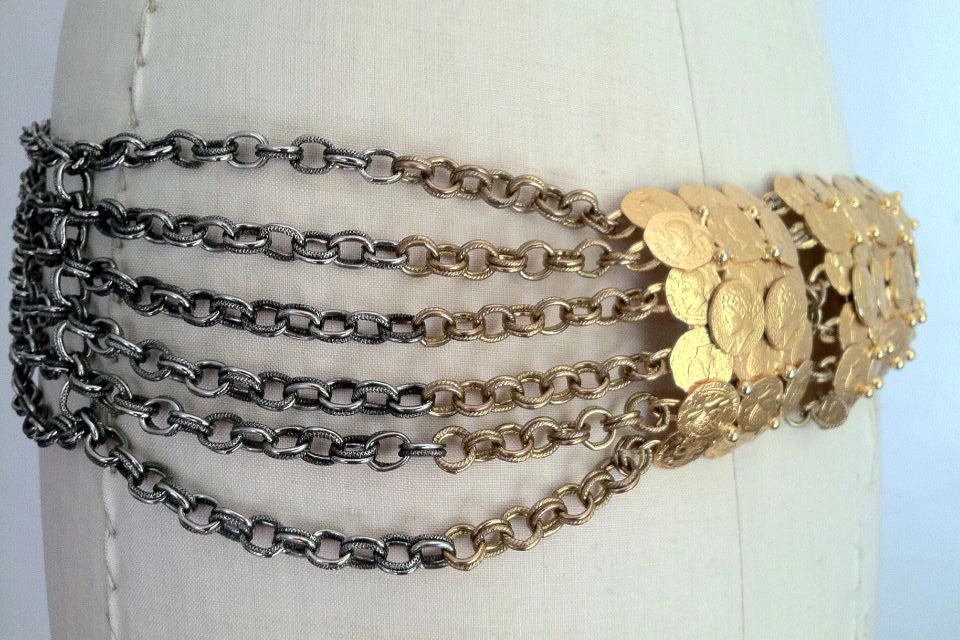 A rare vintage William de Lillo buckled chain belt. Authentic two tone gilt and burnished silver tone metal chains item with a very large gilt 'ancient coins' buckle (buckle measures 8