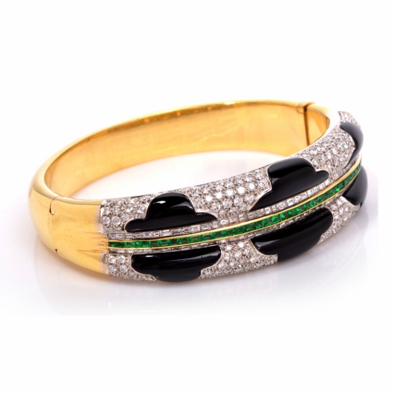 An unforgettable statement of beauty, this gorgeous bracelet has a lively presence that will catch everyone's eye. Finely crafted in solid 18K yellow gold, it features an exquisite design that is showcases 6 sections of black onyx accented with a