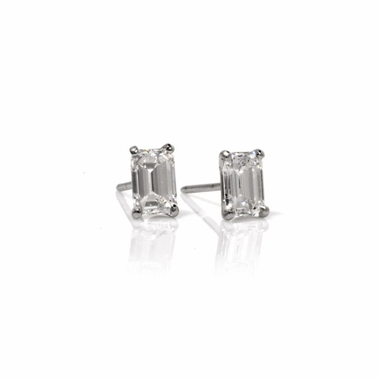 An elegant classic, these diamond stud earrings are a must have , sparkling with brilliance! Finely crafted in solid platinum, these earrings are set with 2 genuine GIA graded emerald diamonds, each are  approx. 1.01ct, F color, SI1 clarity, TDW