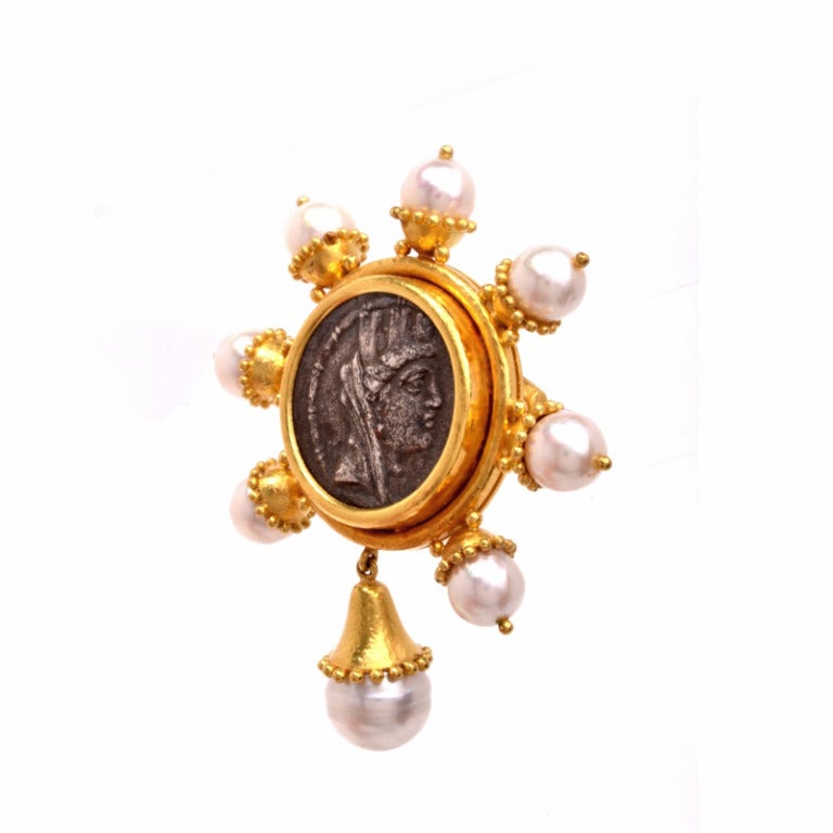Elizabeth Locke creates magnificent pieces that feature the places that she has traveled. This exquisite pin is finely crafted in solid 18K yellow gold and is centered with an ancient Roman coin, bezel set with hand hammered finish. This fashionable
