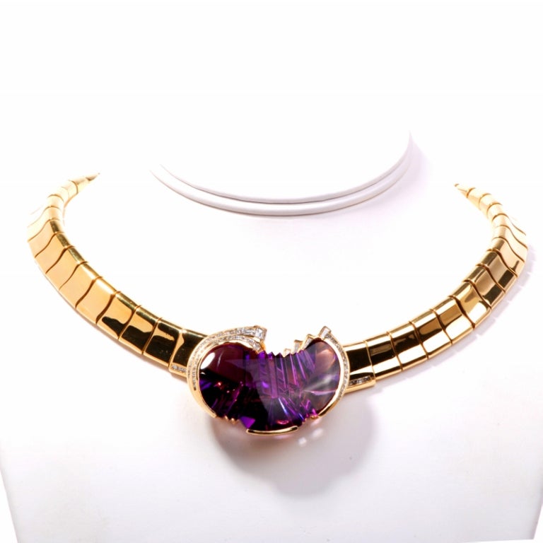 This marvelous high polish Italian necklace is crafted in solid 18K yellow gold. At the center of this stunning piece you will find a divine pendant that is centered with a free form cut amethyst approx 45.00 cttw and is accented with 56 genuine