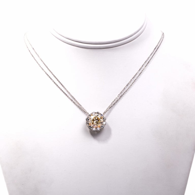 This dazzling and sparkling necklace is a combination of true brilliance and fine luxury. Finely crafted in solid 18K white gold, this necklace features a breathtaking pendant that is set with 1 genuine natural fancy light yellow natural diamond