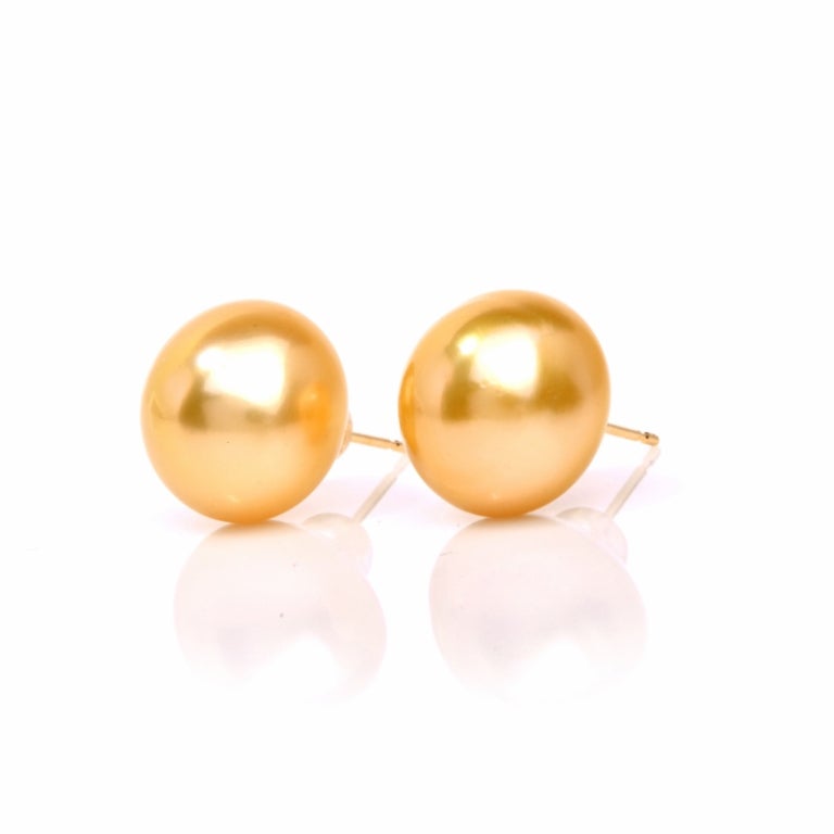 Exceptionally elegant, these lustrous pearl earrings are a quintessential must have item for any jewelry collection. Finely crafted in solid 18K yellow gold, these earrings are set with 2 genuine lustrous golden genuine South-Sea  pearls approx.