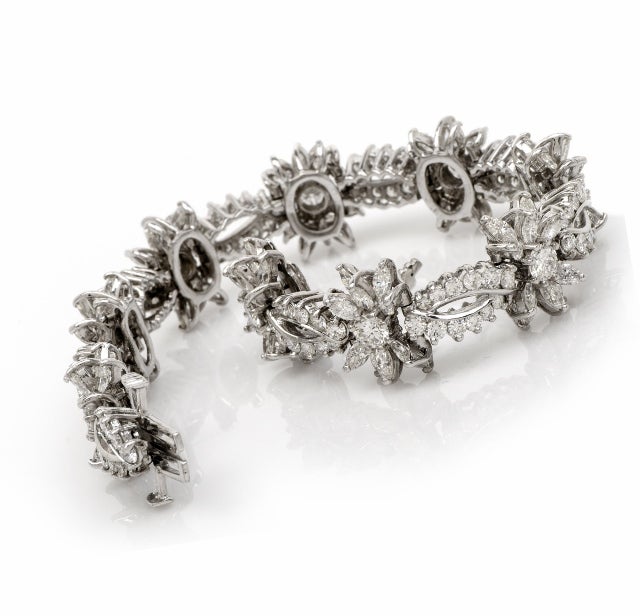 This stunning estate bracelet is crafted in solid platinum with full of decadence and radiance.This piece features 9 interval diamond cluster links with 9 genuine round cut diamonds approx: 3.50 cttw, I color, VS clarity. This platinum diamond