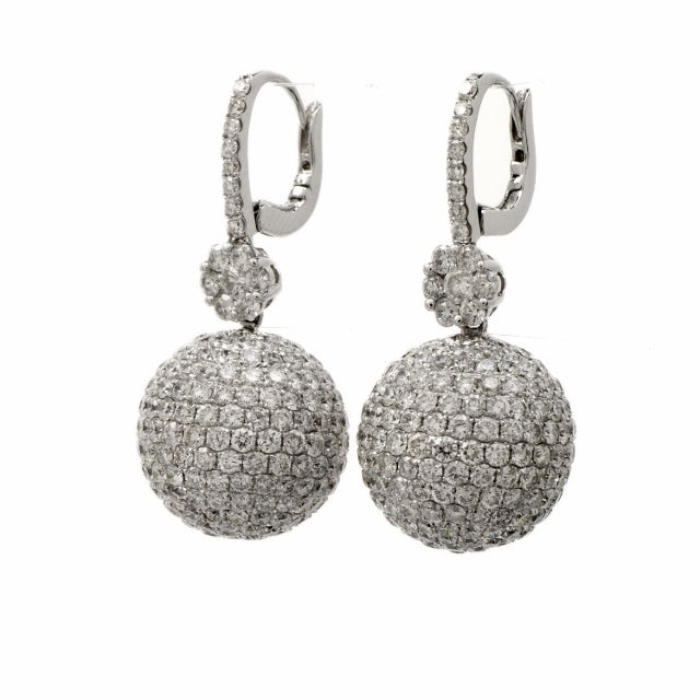 This gorgeous estate clip dangle earrings are crafted in solid 18K white gold. Showcasing a dangling ball bead design and are encrusted with approx. 450 genuine round cut sparkling diamonds  all adding up to approx: 10.00 cttw, H-I color, VS1