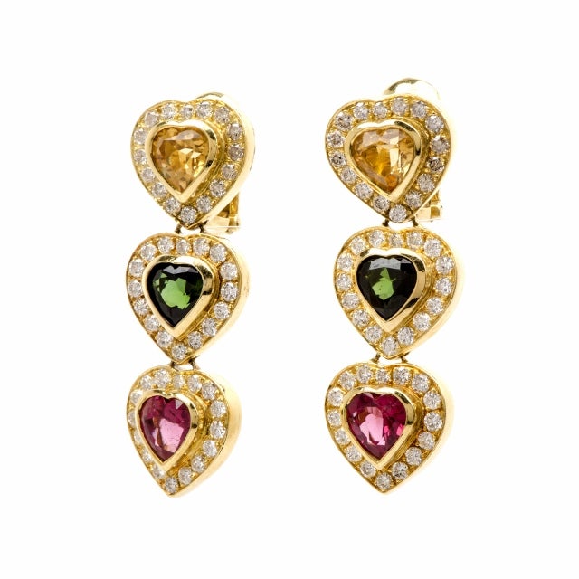 These astonishingly colorful estate citrine and tourmaline earrings are crafted in 18K yellow gold, weighing approx. 32.0 grams and they measure approx. 1.90" long.  Composed of three vertically positioned heart-shaped profiles, these