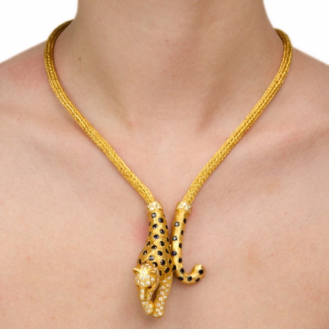 This superbly designed Retro necklace is a constituent part of a three-piece set, together with a ring and a bracelet of identical design.  It is crafted in a combination of matted and polished yellow gold, weighs 79.8 grams and measures 18” long. 
