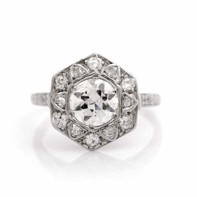 This authentic Art Deco diamond engagement ring crafted in platinum weighs 5.9 grams, measuring 11mm wide and 7mm deep. Designed as an alluring, geometrically inspired hexagonal plaque, this Art Deco ring of classic, timeless elegance exposes at the