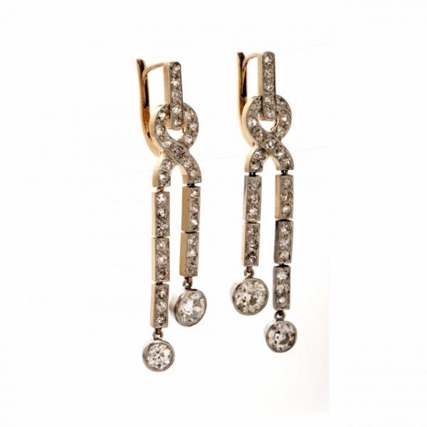 These alluring antique earrings of impressive feminine appeal are crafted in solid 18K rose gold with solid platinum top. They weigh approx. 8.5 grams and measure approx. 45mm long and 10mm wide (on ear clips). In delicate, turn of the century