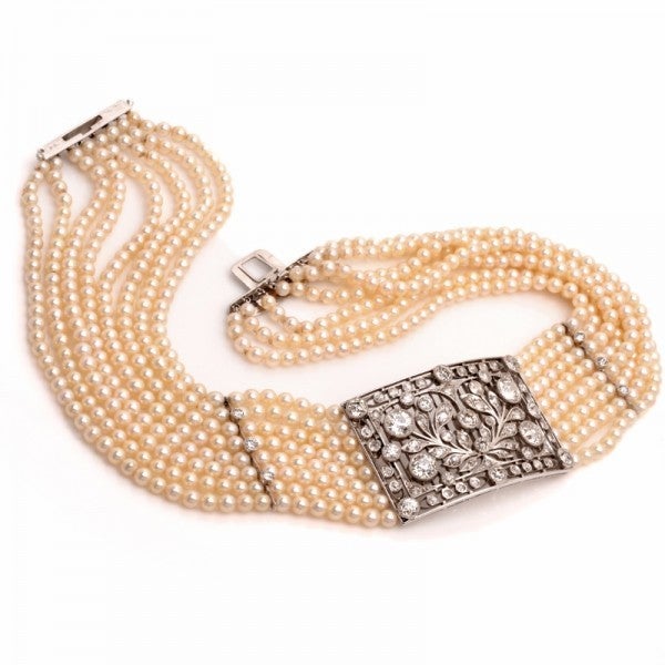 This classically  elegant and elaborately detailed antique choker necklace is finely crafted in solid platinum, this choker necklace is comprised of 8 strands of lustrous genuine pearls measuring approx. 4mm in diameter. An ornate, rectangular 