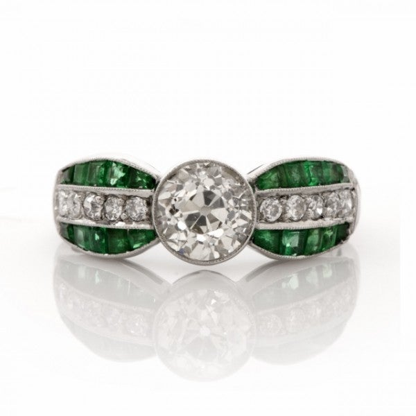 This antique diamond and emerald engagement ring is crafted in solid platinum and weighs approx.5.9 grams.  Immaculately designed to create an outstanding aesthetic, this antique engagement ring exposes at the center a genuine 1.32ct Old