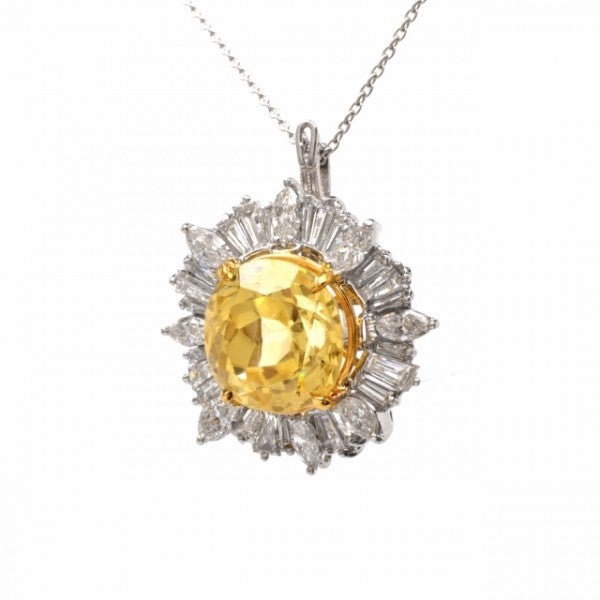 This absorbing vintage pendant necklace is crafted in solid platinum and weighs approx. 16.6 grams. Designed to simulate an enchanting 'sunflower', this captivating pendant exposes a significant 13.70ct genuine and translucent round-faceted yellow