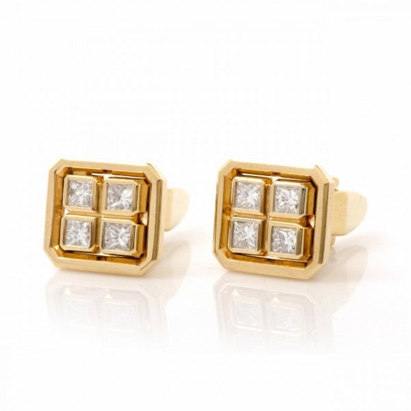 These classically distinct cufflinks designed by Peter D'Lucio are crafted in solid 18K yellow gold, weighing approx. 16.4 grams and measuring approx. 15mm x 13mm. The cufflink faces are designed as  rectangles with delicately beveled corners, each
