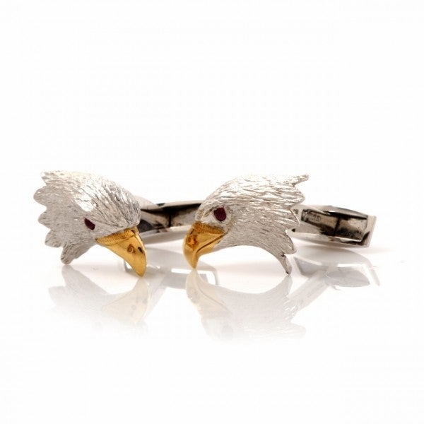These eagle's head cufflinks with white gold head, yellow gold beak and ruby eyes are of English provenance, designed by the famous E. Wolfe & Co. of England. These enchanting cufflinks crafted in solid 18K white and yellow gold, weigh approx. 20.6