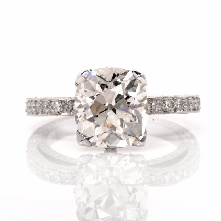 This exquisite Beaudry diamond engagement ring is full of glamour and elegance, a gorgeous and romantic way to express your love. This exquisite ring is finely crafted in solid platinum, and is centered with 1 genuine Antique cushion cut diamond