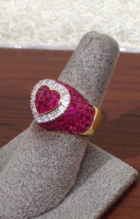 12.69 carats of Ruby, .31 carats of Diamond set in 18k yellow gold.

Currently a size 6.5 but can be sized. 