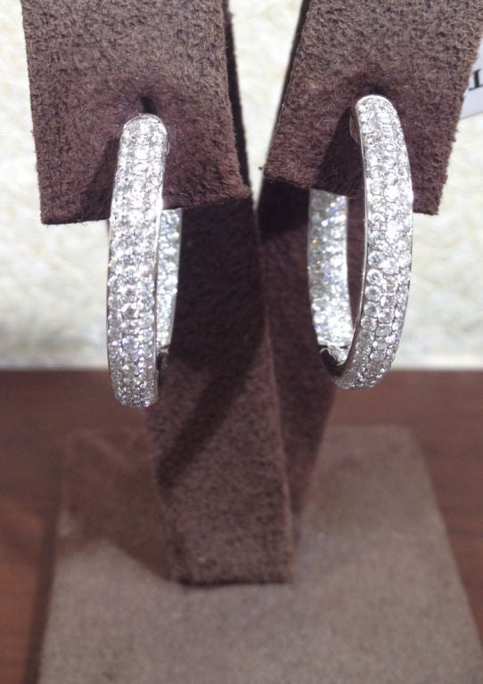 Pave diamond hoops. 2.47 carats of white brilliant diamonds set in 18k white gold. Diamonds are set on the inside and outside of the hoops. 1 inch diameter.
