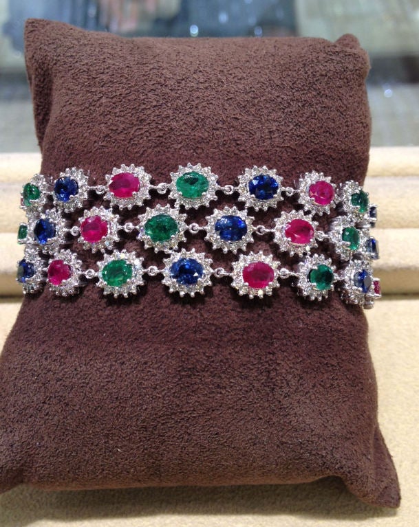 A beautiful bracelet to add to any collection. Over 27 carats of fine Emerald, Ruby and Sapphire. Set in 18k white gold and bordered by 6.75 carats of diamonds.