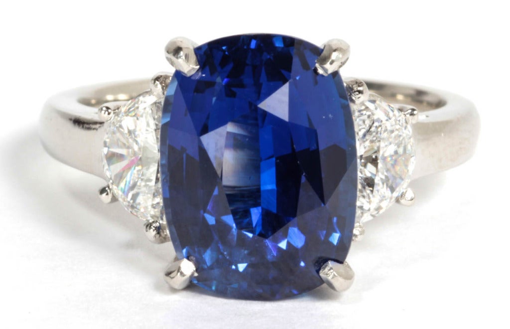 Certified natural no heat 6.09 carat Cushion cut sapphire set in handmade platinum and diamond mounting. .66 carats of diamonds. 

This sapphire has exceptional color and brilliance. 

The certificate states the color as VIVID BLUE and CORNFLOWER