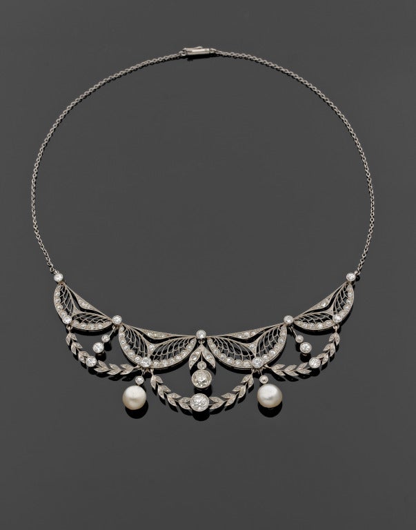 VENTRELLA 1910 Necklace in platinum, old cut diamonds and natural pearls 8 mm and 7,50mm (not tested), four half moon elements, articulated garland, two pendants set with pearls, can be mounted as a tiara, signed case, 37,50cm (23.95 grams)