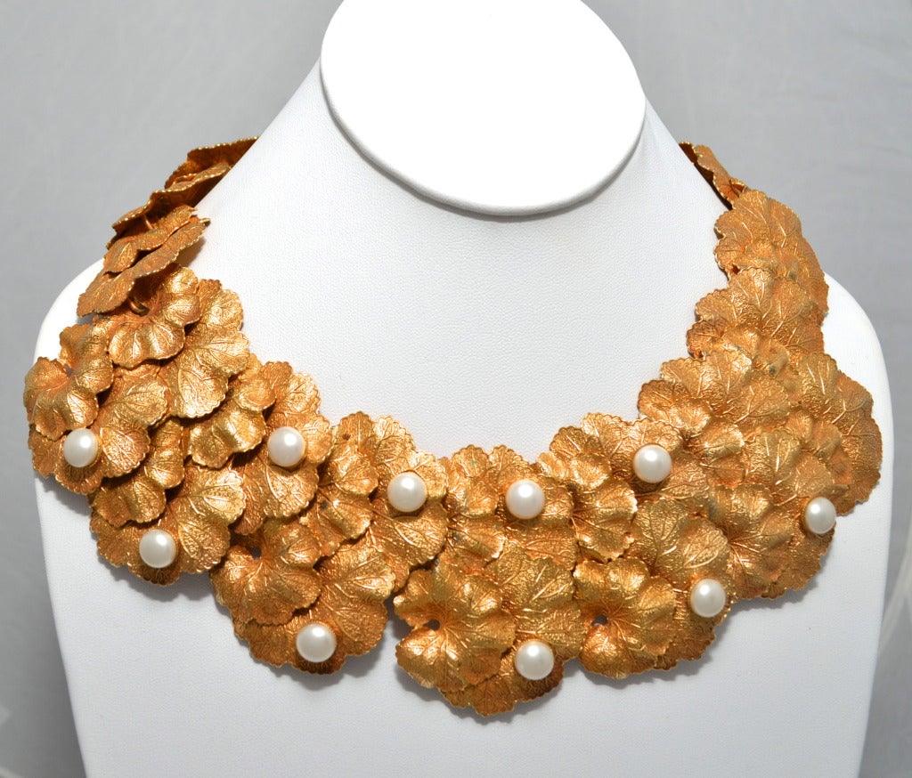 1980's Dominique Aurientis Paris cast gold leaf and faux pearl necklace and earring set. Bold statement necklace with 2 rows of layered articulated gold tone leaves with pearls set in some leaves. Set is completed by large drop clip on earrings that