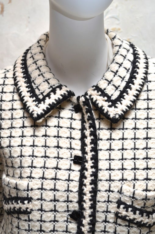 Chanel black and white boucle wool coat with braided trim and leather belt. Size 38. From the 2000A collection. Hip pockets.