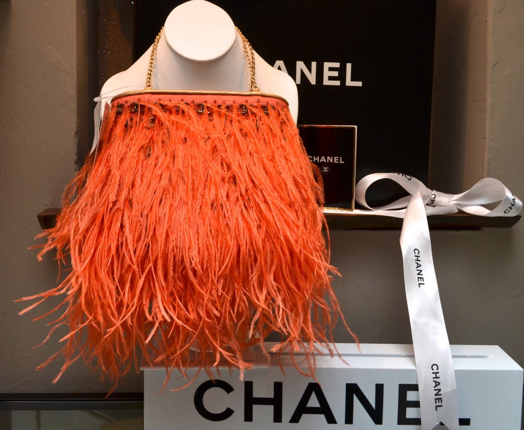 Chanel Orange Ostrich Feather Handbag with CC Logo Beading Gold Leather Lining
New Old Stock, Tags attached
Comes with box and dust bag
Exotic slice of feather heaven!!!