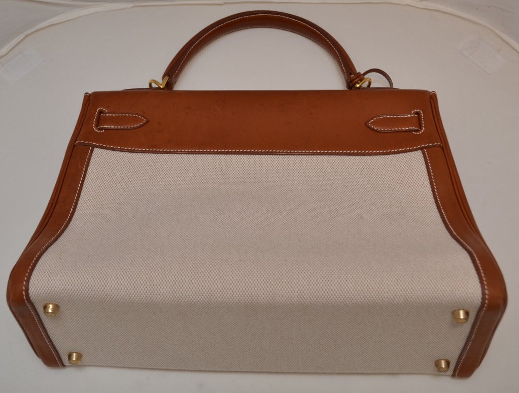 Hermes 32 CM Kelly Handbag
2002
Gold hardware
Removable shoulder strap
Canvas is very clean, there are water spots to brown leather as if left on a yacht for too long
Inside is clean