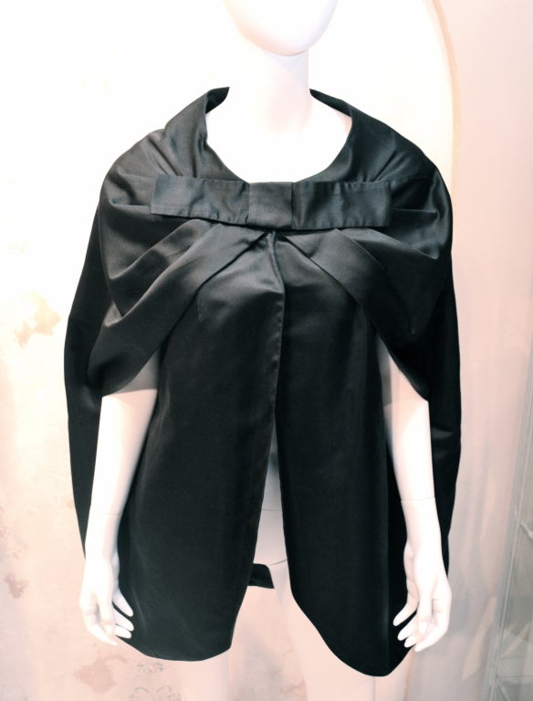 Don Loper Beverly Hills draped evening cover-up cape. Very glamorous and minimal. Nice draping through the shoulders. Large bow on front. 

Excellent Condition