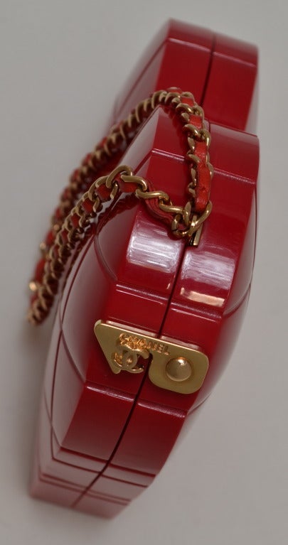 Chanel collectable red lucite or plastic minaudiere with optional leather chain strap. Leather lined. These are impossible to find. Excellent condition.