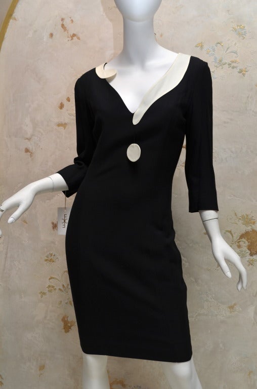 Moschino Couture Question Mark Dress 1989
Black crepe cocktail dress with white rayon crepe question mark around the neckline. Fully lined. Three quarter sleeves. Size 6