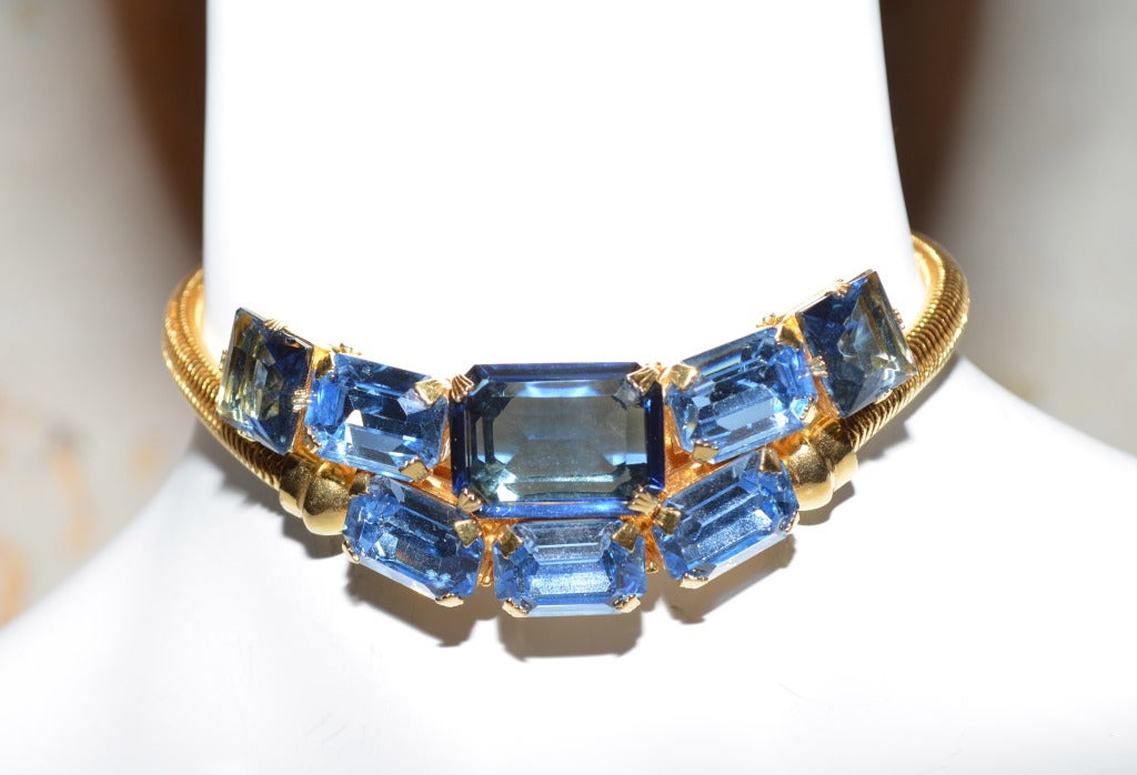 Blue rhinestone choker and bracelet with gold toned serpentine chain. Excellent quality of construction. Reminiscent of 1940's Van Cleef and Arpels jewelry. Necklace and bracelet are caged on the back side to fit to the body. Shiny gold toned metal