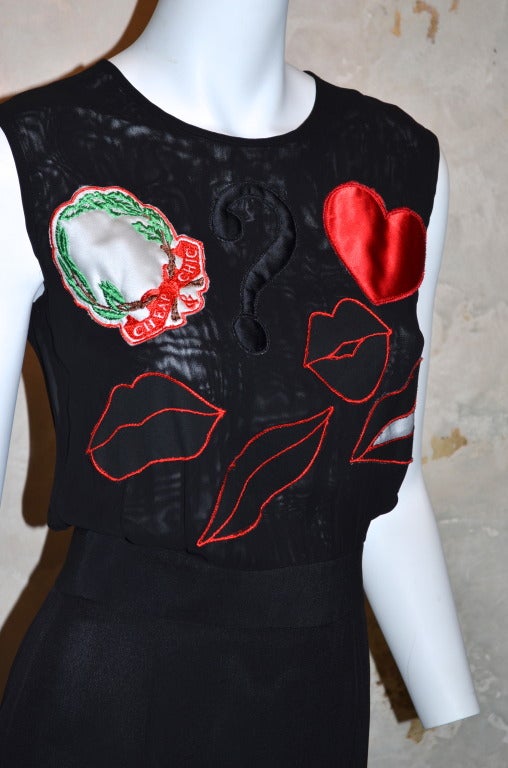Moschino Cheap and Chic Charms Symbols Heart Peace Lips and ? Dress

Organza sleeveless bodice with Heart, Lips Peace Sign and Question Mark symbols embroidered on to the front. Buttons and zips down the back. Attached skirt is made of crepe.