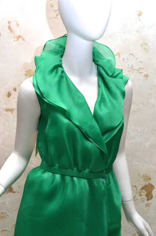 Halston Organza wrap Dress with Ruffle Collar Vintage 1970's
Minimalist construction consisting of 2 layers of organza draped with no seams showing on the skirt
Side seams at underarms to waist
Wrap Dress with 2 hook closures at front