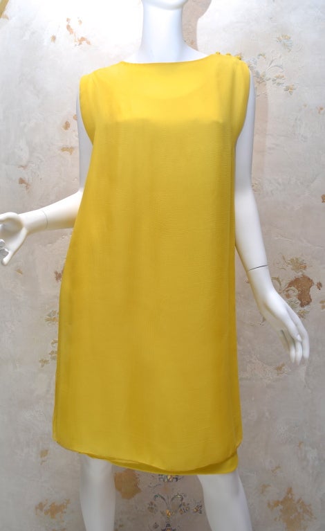 James Galanos for Amelia Gray of Beverly Hills yellow layered chiffon sheath dress made of layers of silk chiffon. Dress is made up of two pieces, first, a structured slightly fitted tank dress under layer that has a scoop neck that is lower in the