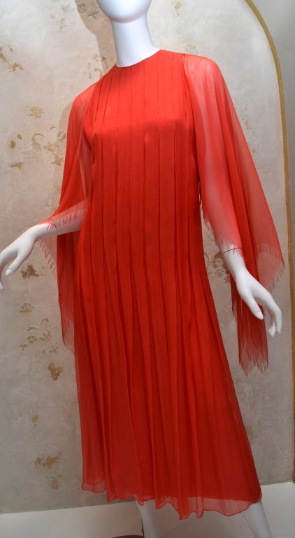 James Galanos 1970's layered and pleated chiffon day dress from Amelia Gray of Beverly Hills. Dress has sheer chiffon sleeves with diagonal fringed finish. Matching fabric belt which can be removed. Very light airy feel to this dress and a lovely