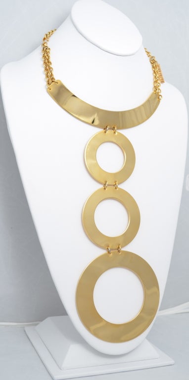 Givenchy gold collar necklace with 3 graduating modern circles. Shiny gold plated base metal. I have seen the same necklace in a silver color as well. Metal plate attached and signed Givenchy. Necklace chain will accommodate up to a 16 1/2