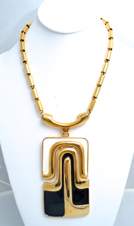 Pierre Cardin vintage modern gold tone metal and enamel necklace. Articulated white and black enamel with negative space in between. Pendant measures almost 5