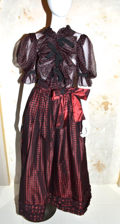 Yves Saint Laurent Rive Gauche see through polka dor blouse with taffeta ball skirt. Great example of mixed prints, colors and textures. Sheer silk top has grosgrain bows that tie over the buttons down the front. Skirt has square print made up of