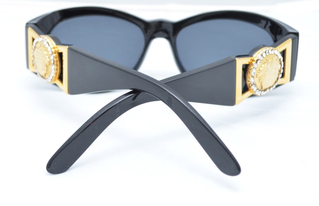 Vintage 1980's Gianni Versace gold Medusa Sunglasses MOD 424/CRHCOL852BK

Very clean, hardly, if at all, pre-worn condition, original case included, gold medusa is surrounded by tiny rhinestones.