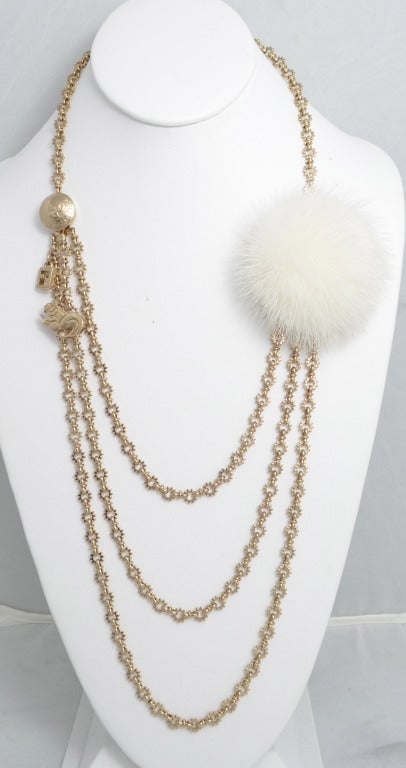 Fendi mink and chain necklace with logo charm and small squirrel like charm. Unusual chain looks like a sun. Opening clasp. Signed Fendi made in Italy on the back of the mink. Chain measures 34