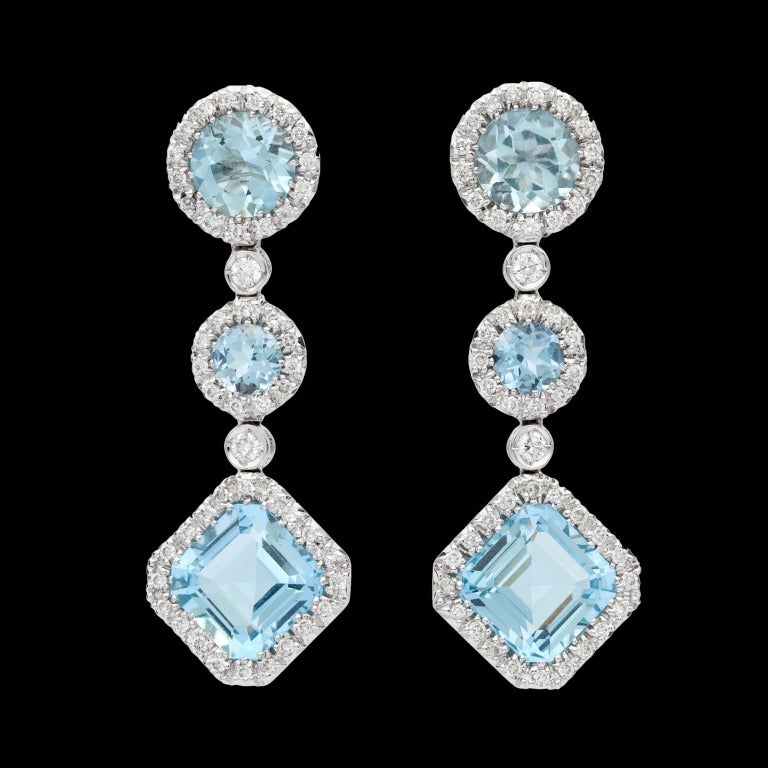 Favero Aquamarine & Diamond Dangle Earrings, set in 18Kt White Gold and feature 6 Mixed Cut Aquamarines for approximately 6.96cts accented by approximately 0.62cts of Round Brilliant Cut Diamonds.  Earrings weigh 12.38 grams, and
measure 13mm