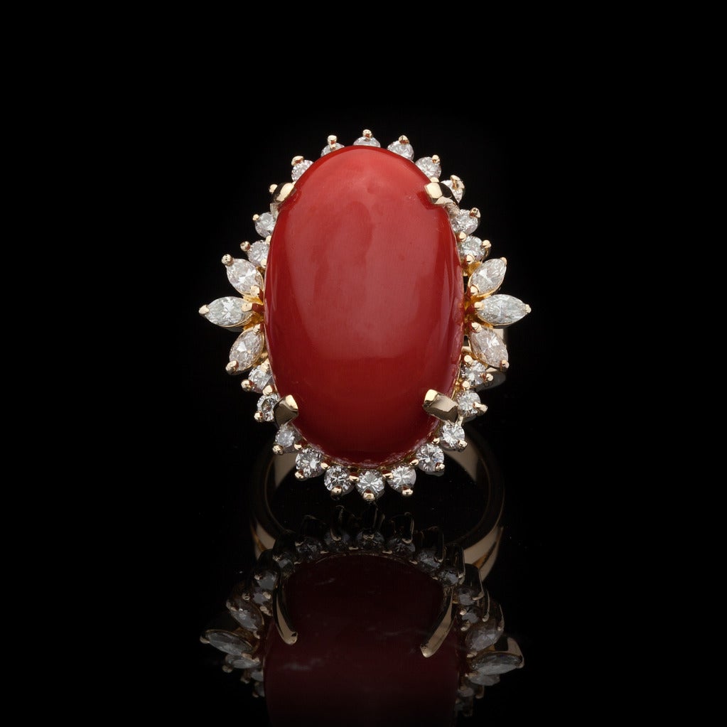 Fabulous 18Kt Yellow Gold Oval Cabochon/Loaf Cut 27ct Coral Ring set with approximately 1.22cts of Mixed Cut Diamonds.  The total weight of the ring is 19 grams and is a size 7.