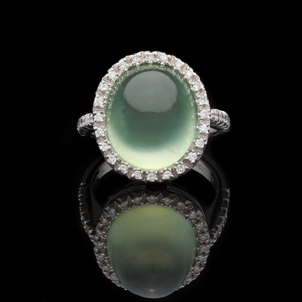 Favero 18Kt White Gold Oval Cabochon Cut 11.81ct Prehnite Ring set with approximately 0.30cts of Round Brilliant Cut Diamonds.  The cabochon measures 15mm x 17mm, total weight of the ring is 8.4 grams and is a size 6.75.