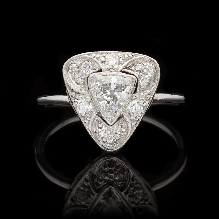 Vintage Ring features 1 Trillion Cut Diamond for approximately 0.45cts set in Platinum with an additional 12 Round Cut Diamonds for approximately 0.21cts.  Ring is size 5 and weighs 2.55 grams.