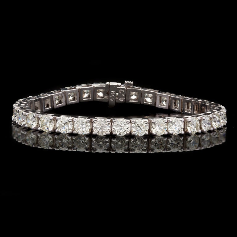 14.03ct tw Diamond Tennis Bracelet features 34 Round Brilliant Cut Diamonds set in 14Kt White Gold.  Bracelet measures 7â?³ long and 4.5mm in width, with a weight of 21.1 grams.