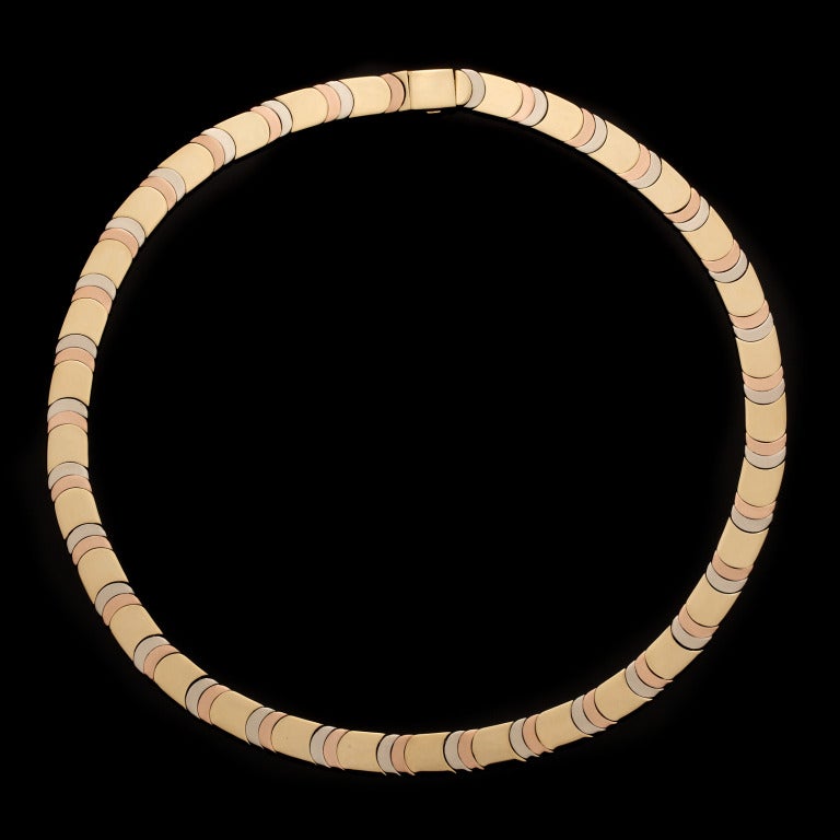 Chimento 18Kt Tri-Color Gold flat choker necklace, reversible to Solid Yellow Gold, weighs 64.9 grams and measures 16″ long x 8mm wide.