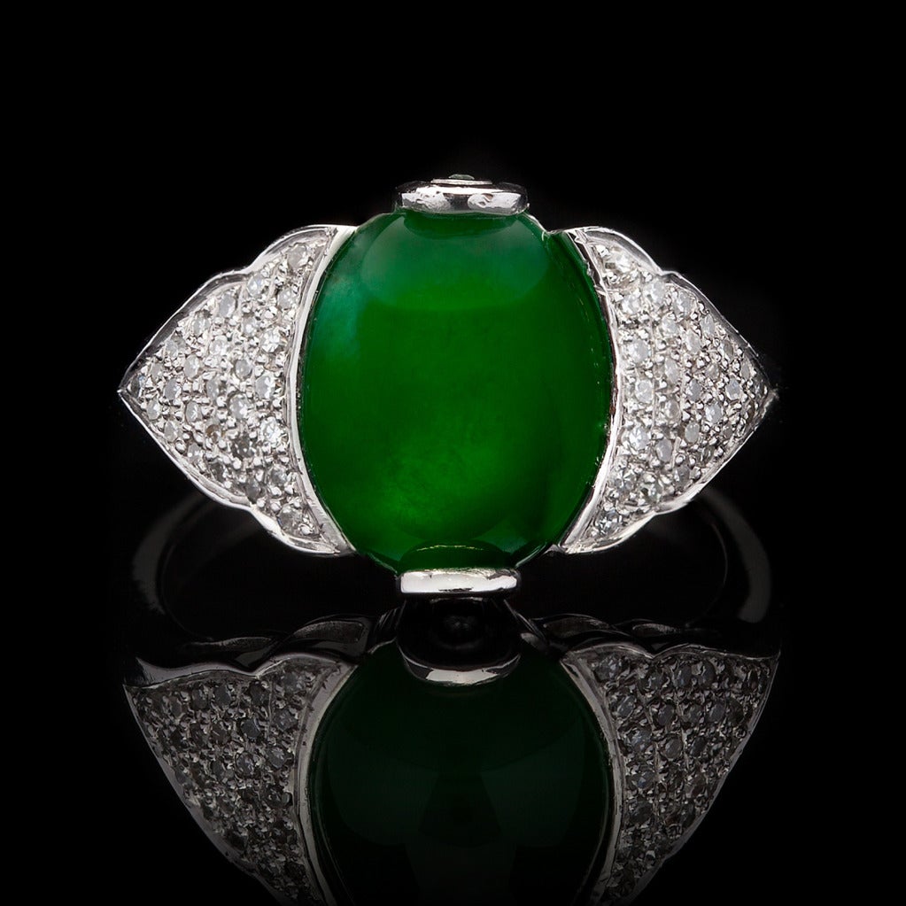 Platinum Oval Double Cabochon Cut Jade Ring set with 58 Round Brilliant Cut Diamonds for approximately 0.50cts. The total weight of the ring is 7.7 grams and is a size 7. Jade is natural with no indications of impregnation and GIA report #